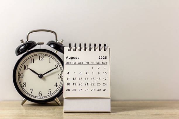 istock A desktop calendar for August 2025 and a clock on the table, where there is room to copy. 2211538871