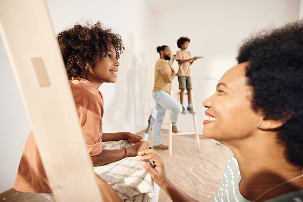 istock Happy black girl and her mother talking during home renovation process. 2211540167