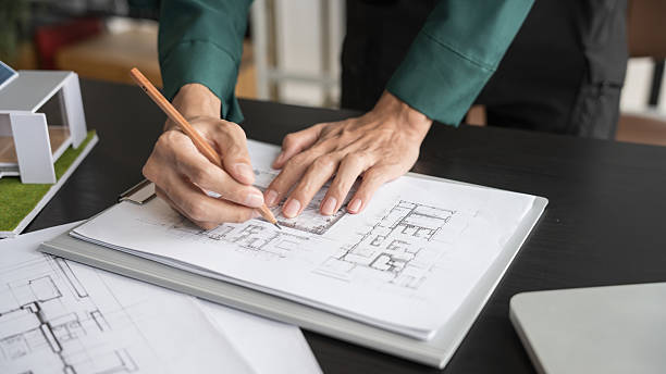 istock Architecture Man drawing on architectural Creative project business architecture building constructionÂ Industrial engineering Achievement Planning Design on eco blueprint 2211540299
