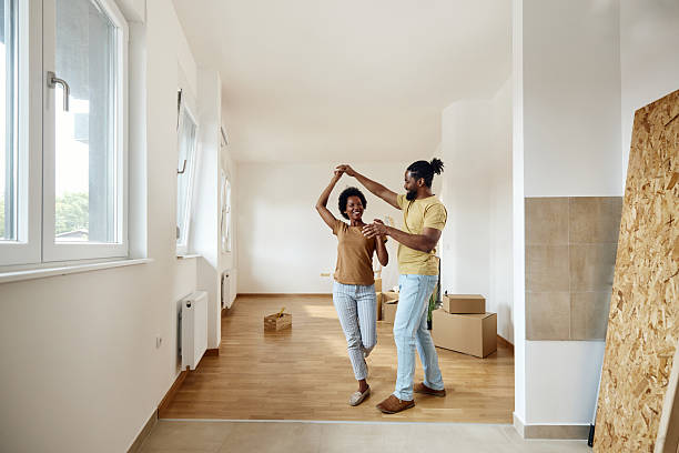 istock Happy black couple having fun while dancing in their new home. 2211540643