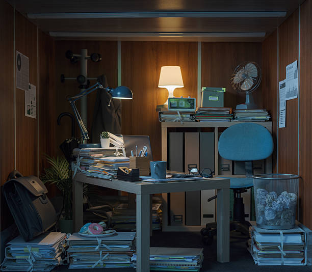 istock Tiny office interior with desk and lots of paperwork 2211543202