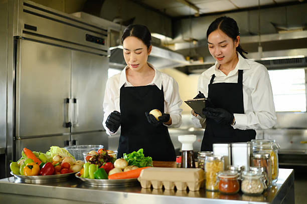 istock Female student learning food preparation techniques in cooking class 2211543822