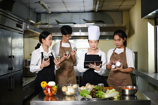 istock Group of young chefs in training learning about ingredients in class 2211543864