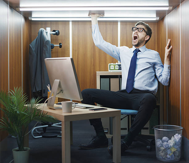 istock Desperate employee trapped in a small office 2211544037
