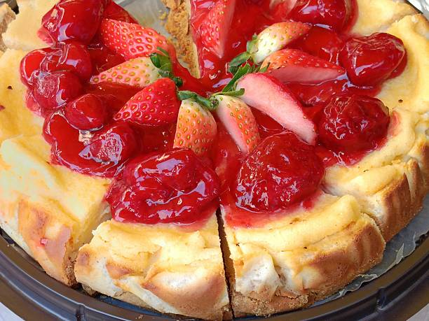 Fresh strawberries and candied cherries pie arranged.