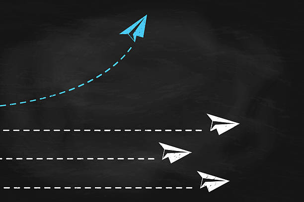 istock Blue paper plane changing direction on black chalkboard. New idea, change concept of business 2211544601