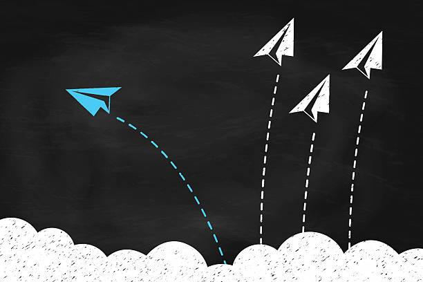 istock Individual and blue paper plane changing direction around the clouds on black chalkboard 2211545194