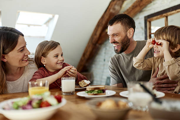 istock Young family talking during breakfast at dining table. 2211546340