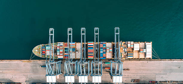istock Top view of a large cargo ship loading and unloading containers at a deep-sea port 2211548644