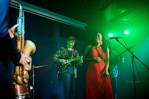 istock Nightclub singer watching saxophonist perform solo 2211549451