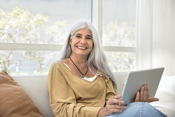 istock Happy senior student woman enjoying online learning application on tablet 2211549659