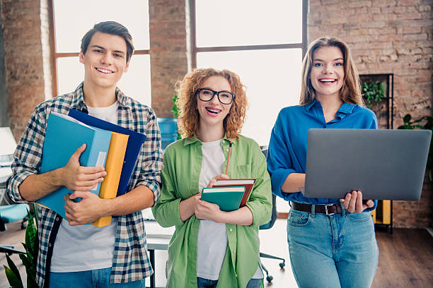 Young, diverse professionals collaborating in a bright office workspace. They portray creativity and teamwork essentials, symbolizing partnership in modern corporate and startup environments.