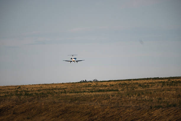 istock Airplane flying over the countryside 2211550399