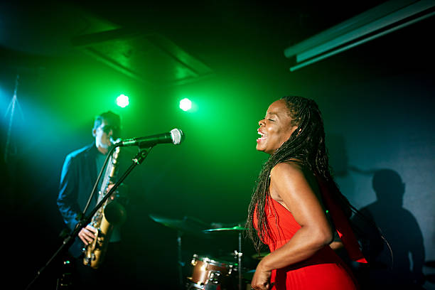 istock Onstage portrait of joyful chanteuse performing with band 2211553321