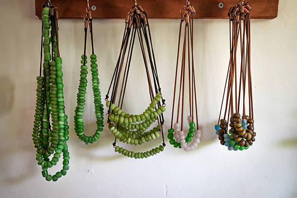 istock Handcrafted Glass Bead Necklaces Hanging on Display 2211553906