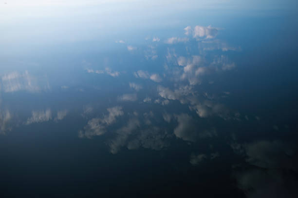 Soft clouds are mirrored perfectly on the calm surface of the Zambezi River near Victoria Falls. The minimalism and serenity of the water create an almost abstract feel, blurring the line between sky and river. This was taken on a tour of the Simalaha Conservancy, a community-based conservation project run by Peace Parks.