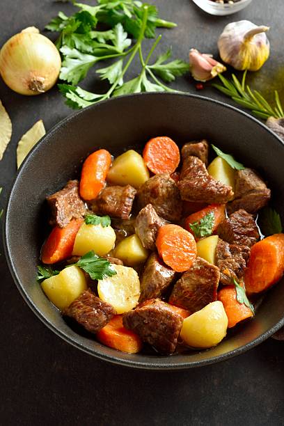 istock Beef stew with potatoes, carrots and greens 2211554873