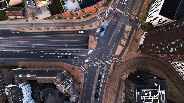istock Directly above road intersection in town at dusk 2211556057