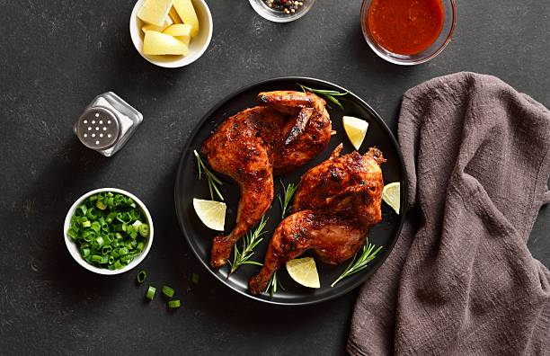istock Grilled half chicken garnished with lemon and rosemary 2211556659