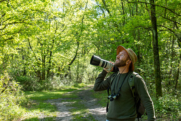 istock Wildlife Photographer Capturing Nature in a Forest 2211557408