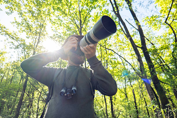 Man with Camera in Lush Forest Capturing Nature