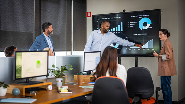 istock Confident Black Businessman Leading a Collaborative Meeting with Diverse Team in Modern Office 2211558042