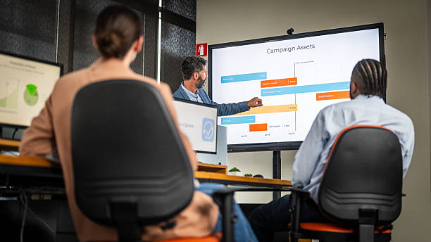 istock Confident Businessman Leading a Collaborative Team Meeting with Engaged Diverse Colleagues 2211558051