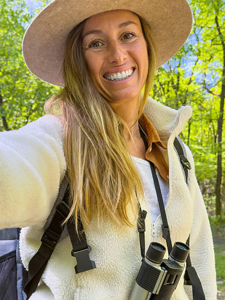 istock Happy Woman Hiking in Forest Taking Selfie 2211558322