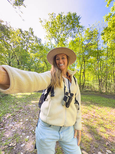 istock Happy Woman Hiking in Forest Taking Selfie 2211558328