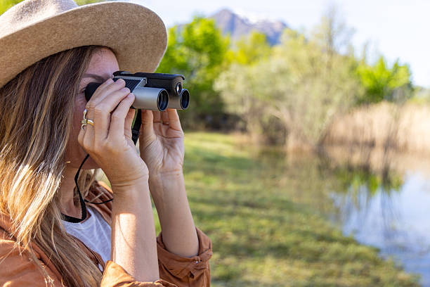 istock Woman Birdwatching at Lakeside 2211558652