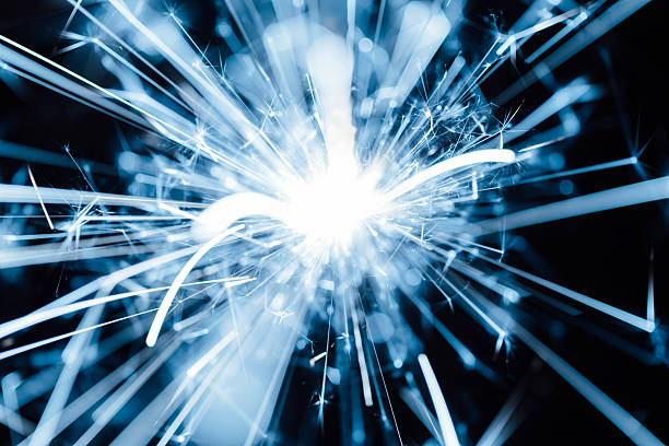 istock Brilliant Blue Sparkles with Dynamic Rays of Light in Dark Background 2211559183