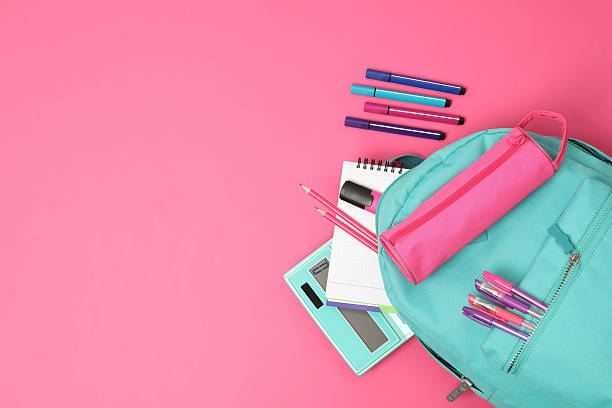 istock Backpack and different school supplies on pink background, flat lay. Space for text 2211560948