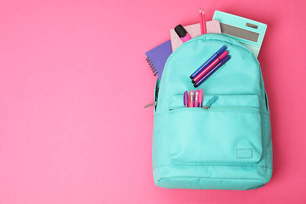 istock Backpack and different school supplies on pink background, top view. Space for text 2211560963