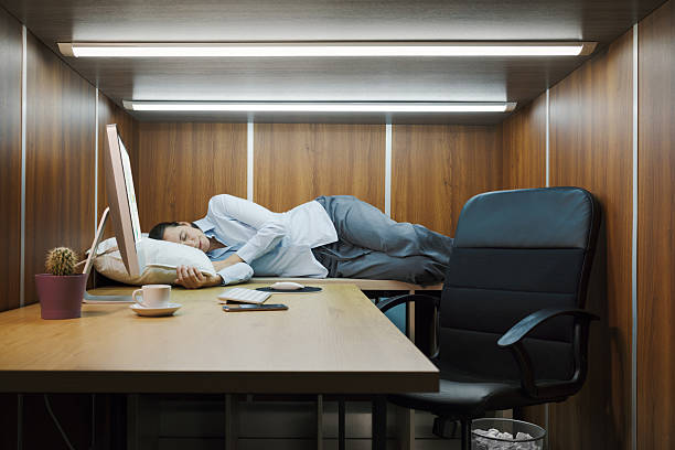 istock Exhausted employee working and sleeping in the same room 2211561533