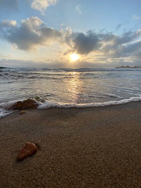 istock Gentle waves caressing sandy shoreline during sunrise, illuminating tranquil coastal landscape in Santa Croce Camerina, Sicily 2211563198