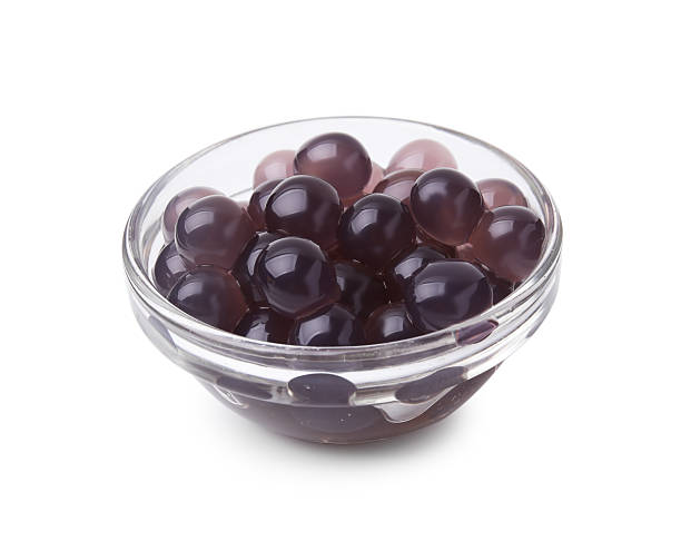 istock Color tapioca pearls in bowl isolated on white 2211564982