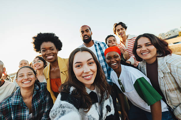 istock Diverse group of friends gathering outdoors while expressing unity and happiness 2211567417