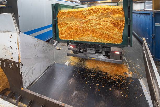 istock Recycling industry. Turning waste food into cattle feed, Industry. Waste chips.Dumping chips by a truck. = 2211568217