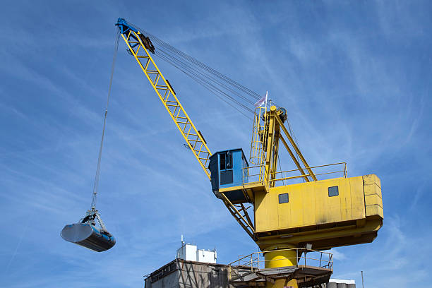 Unloading an inland barge filled with soja  by crane. Transport by ship.