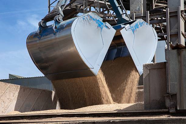 istock Unloading an inland barge filled with soja by crane. 2211568304