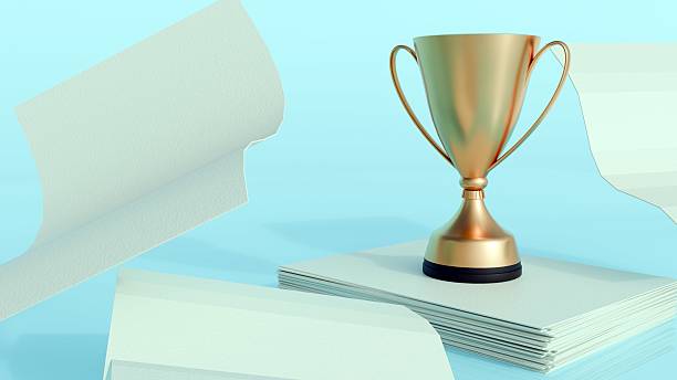 istock A classic golden trophy standing on a neat stack of white papers 2211568471