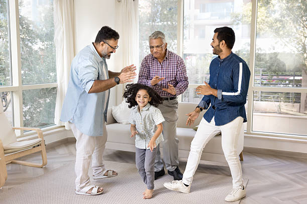 istock Indian men of three generations and kid dancing at home 2211569690