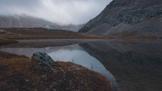 istock Dramatic Alpine Landscape in Autumn Fog 2211572130
