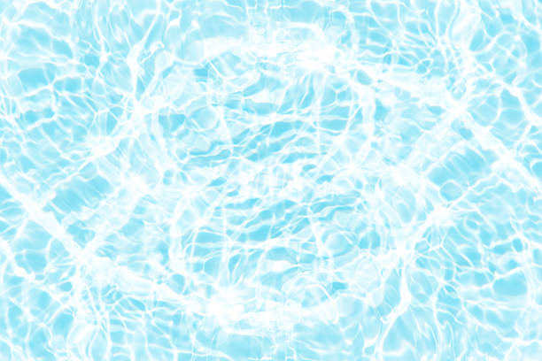 istock Blue water with ripples on the surface. Defocus blurred transparent blue colored clear calm water surface texture with splashes and bubbles. Water waves with shining pattern texture background. 2211573411