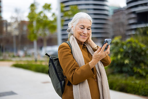 istock Mature woman enjoying a city stroll while making an online call 2211573462