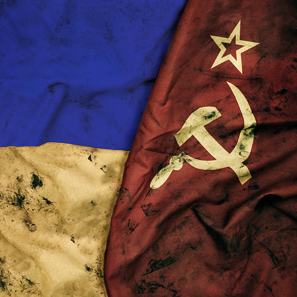 Low key photography of old stained flags of Ukraine and Soviet Union. USSR, CCCP, Russia.