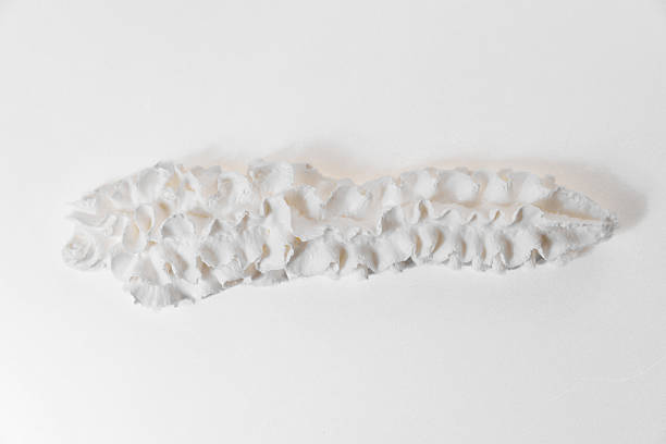 istock Whipped milk cream from the tube is squeezed onto a white surface. 2211577447