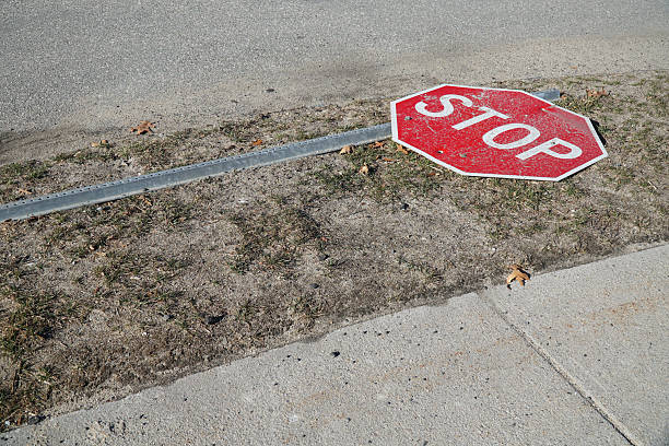 istock stop sign fallen on the road side 2211577952