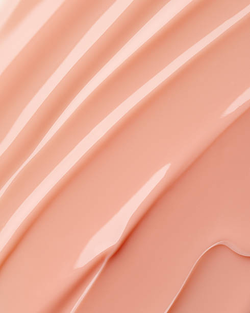 istock Glossy beige cosmetic texture with smooth flowing lines and soft highlights 2211581151