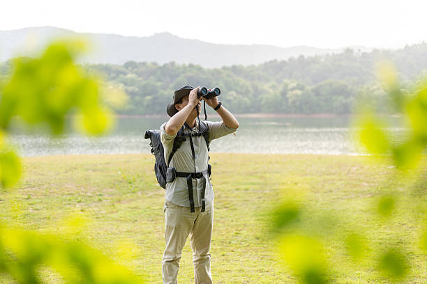 istock Wildlife traveler using binoculars to observe wild animals 2211582766